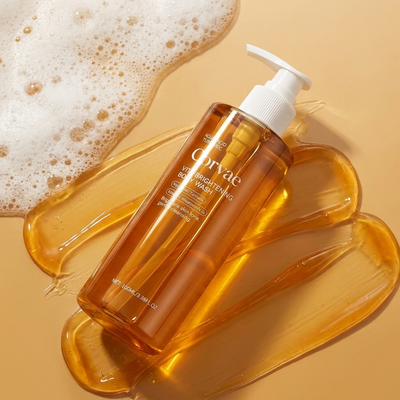 Corvae Brightening Body Wash flat lay on warm gold with product texture