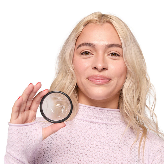 Placeholder: person holding a menstrual disc close-up